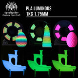 Three glowing PLA plastic craft shapes displayed on black backgrounds with text reading 'PLA LUMINOUS 1KG 1.75MM' and the SpoolSpider brand logo.